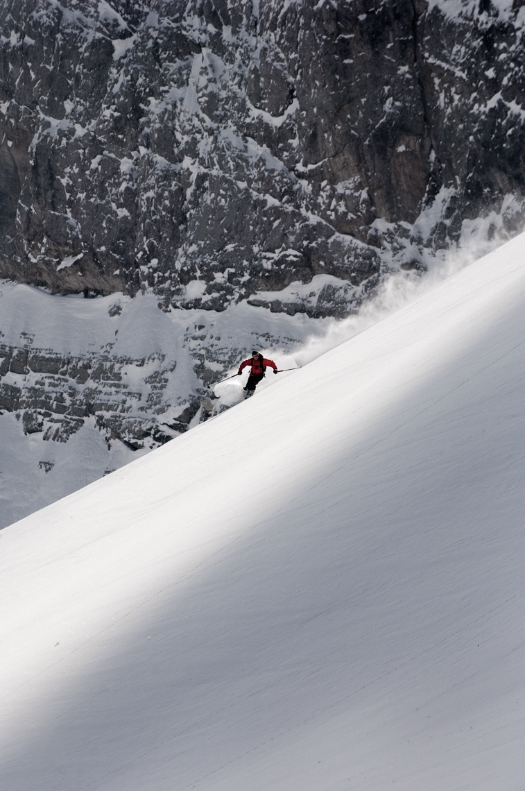 Jon Wyatt Photography - skier in front of cliff, Slovenia