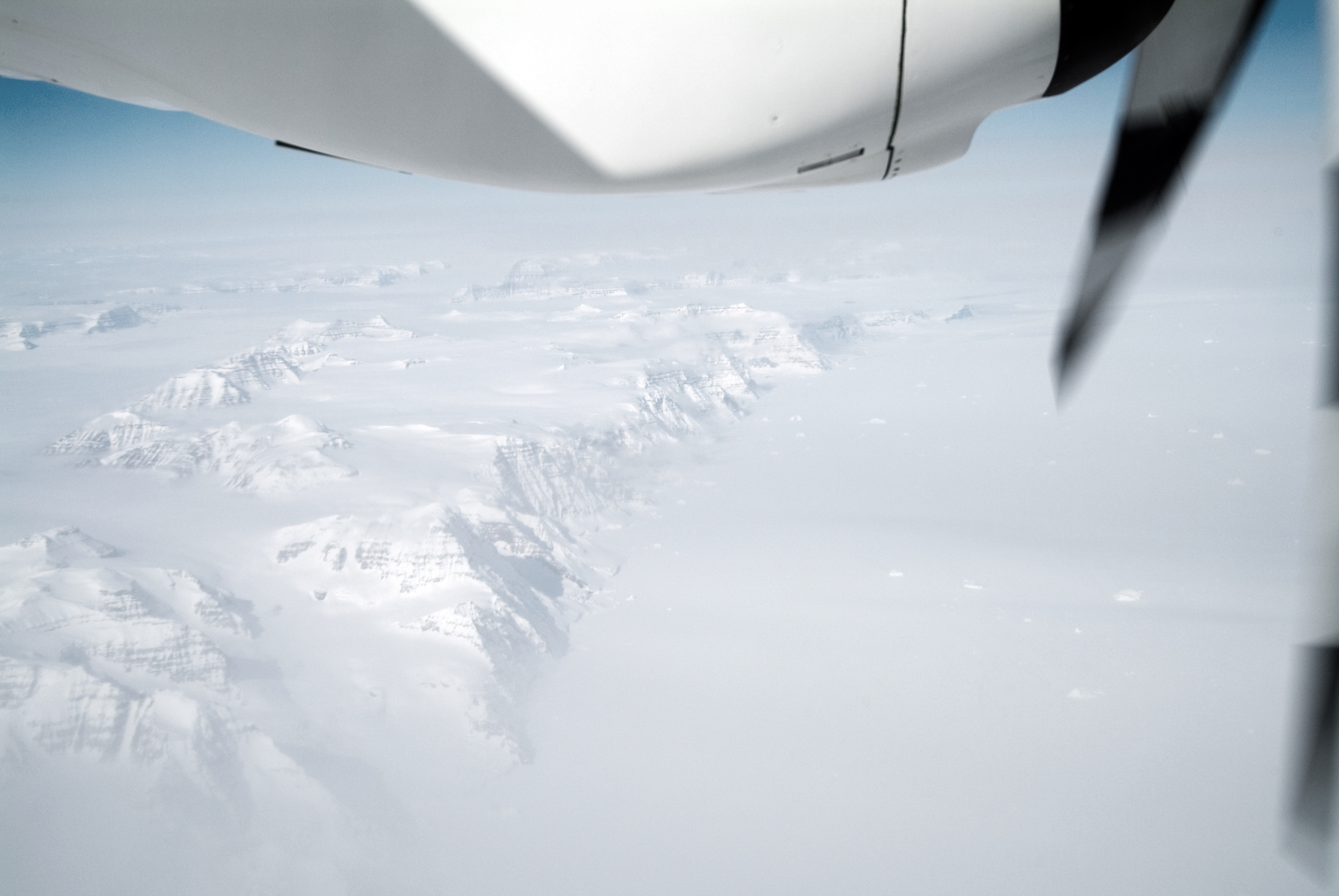 Jon Wyatt Photography - propeller of small plane flying over Greenland